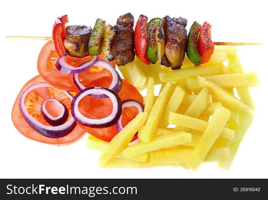 Pork skewers with french fries and vegetable salad