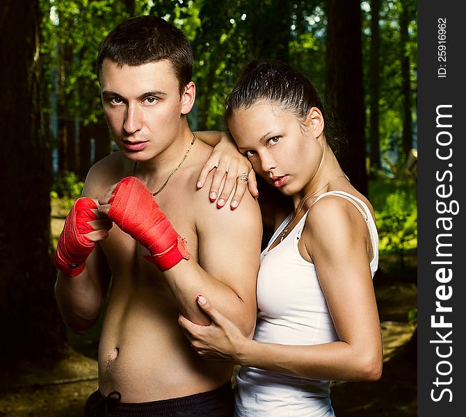 Fashion photo of young men and women are in a combat position and look at the camera. Fashion photo of young men and women are in a combat position and look at the camera