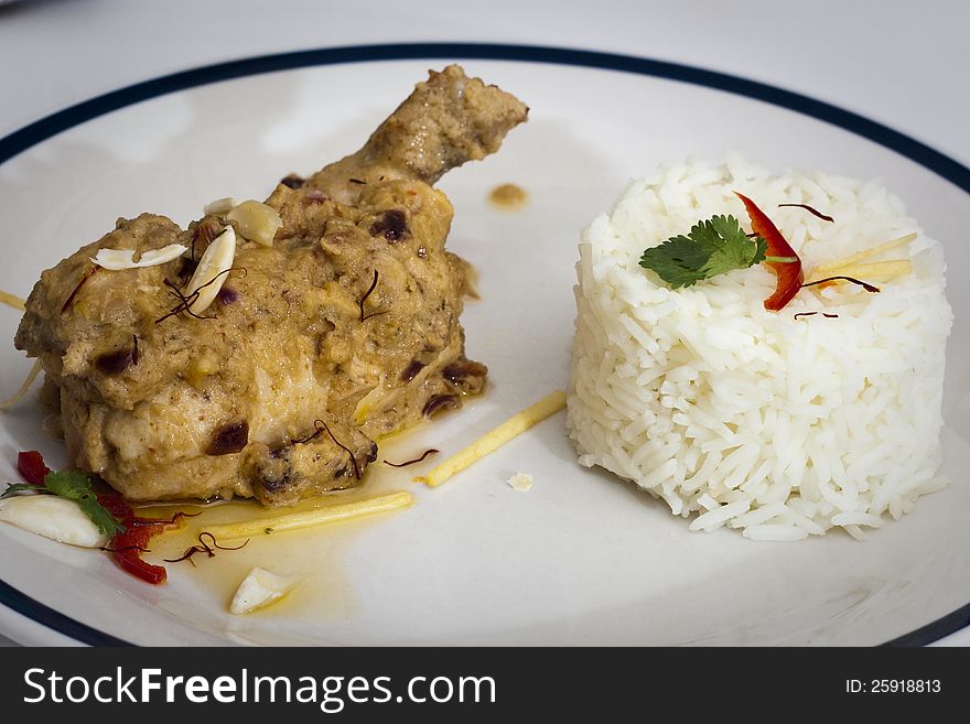 Chicken Wajid Ali from Awadhi cuisine (Eastern Utter Pradesh, India), Chicken breast stuffed with dry fruits and dried milk product (Khoya), served with saffron sauce and basmati rice. Chicken Wajid Ali from Awadhi cuisine (Eastern Utter Pradesh, India), Chicken breast stuffed with dry fruits and dried milk product (Khoya), served with saffron sauce and basmati rice