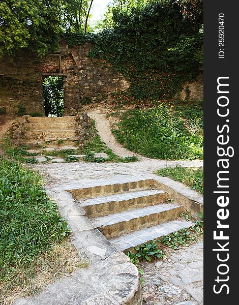 Mysterious wall opening and brick steps in Sighisoara curchyard, Transylvania, Romania.