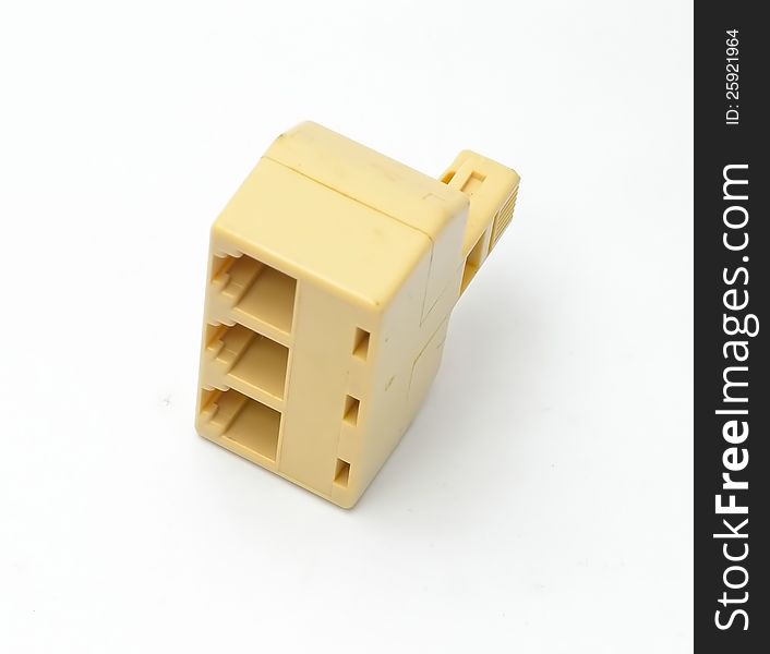 A yellow  splitter plug adaptor for multi phone lines with white background. A yellow  splitter plug adaptor for multi phone lines with white background