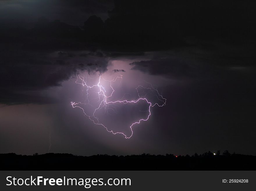 Lightning forming a loop at the bottom of a thunderstorm. Lightning forming a loop at the bottom of a thunderstorm.
