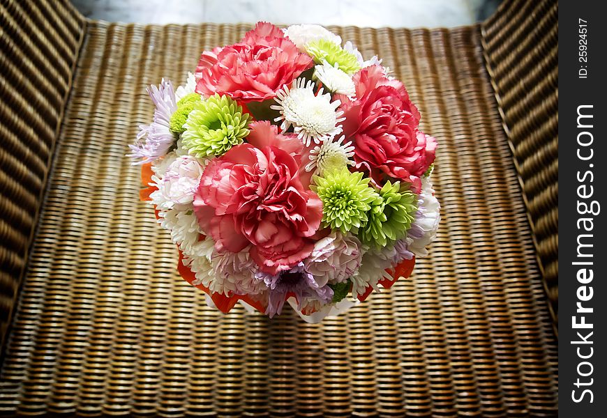 Bouquet of flowers on basketwork chair