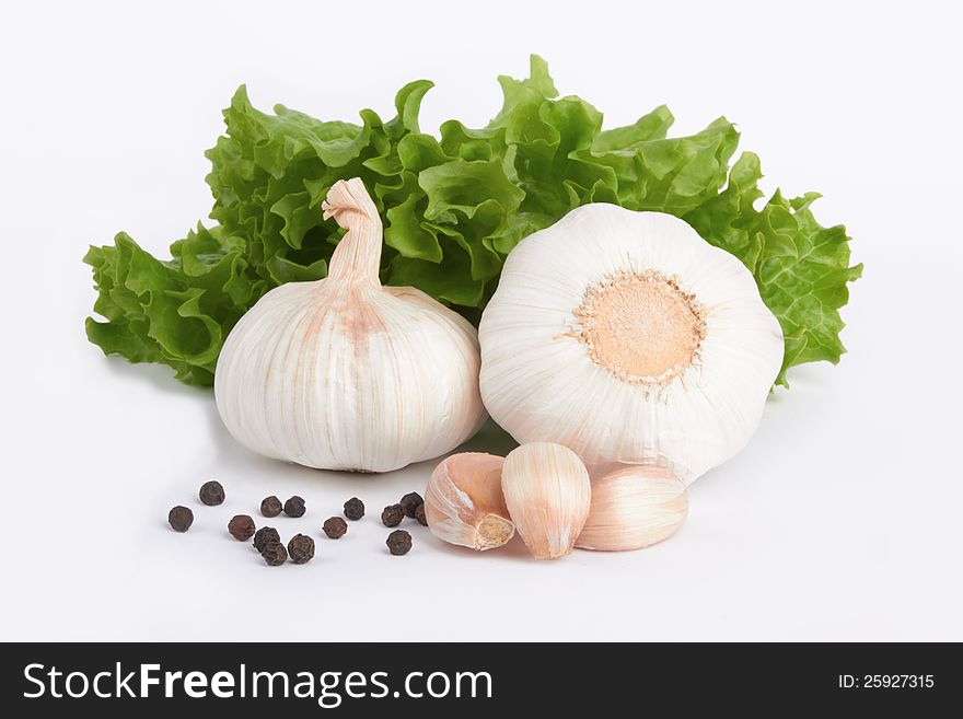 Garlic decorated parsley leaves on white background