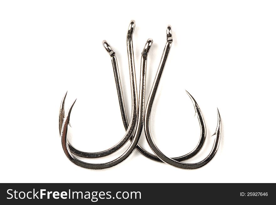 Four fishhooks on a white background