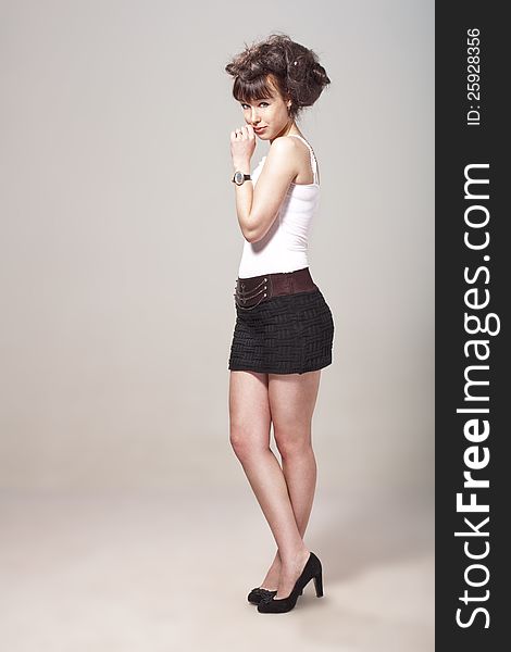 Beautiful girl posing in a black skirt and stilletos. Beautiful girl posing in a black skirt and stilletos