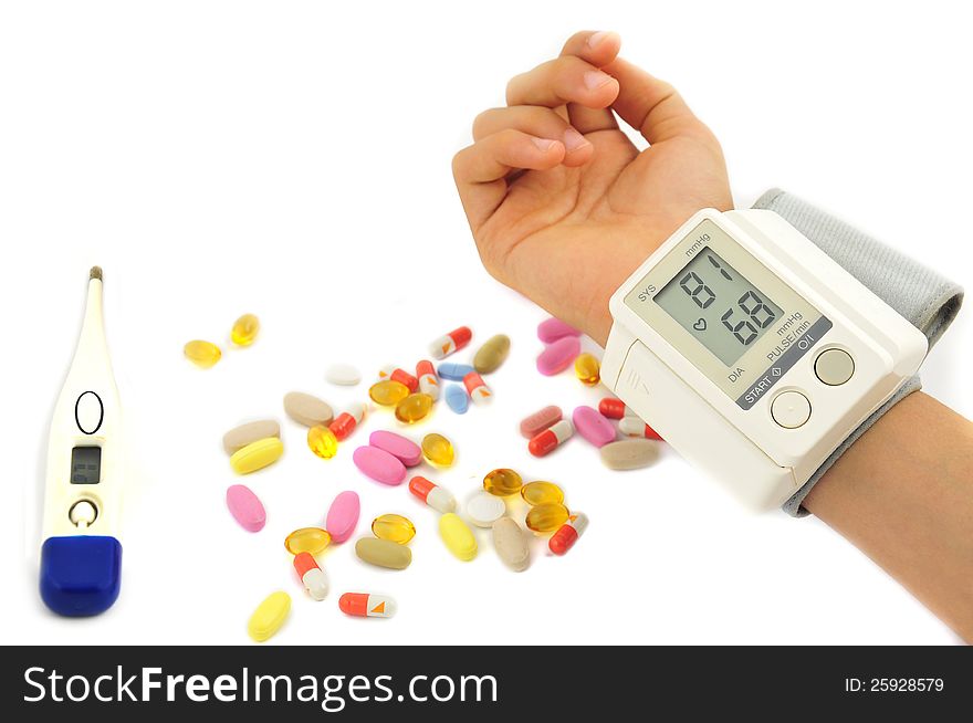 Blood pressure and pills in white background. Blood pressure and pills in white background