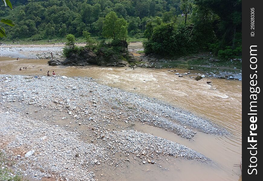 a stream with muddy water flowing after the rain fall