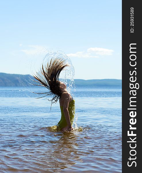 Child in the water waving hair. Child in the water waving hair