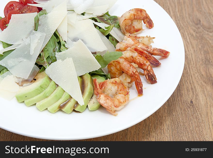 Arugula dish with shrimp in a restaurant on the table