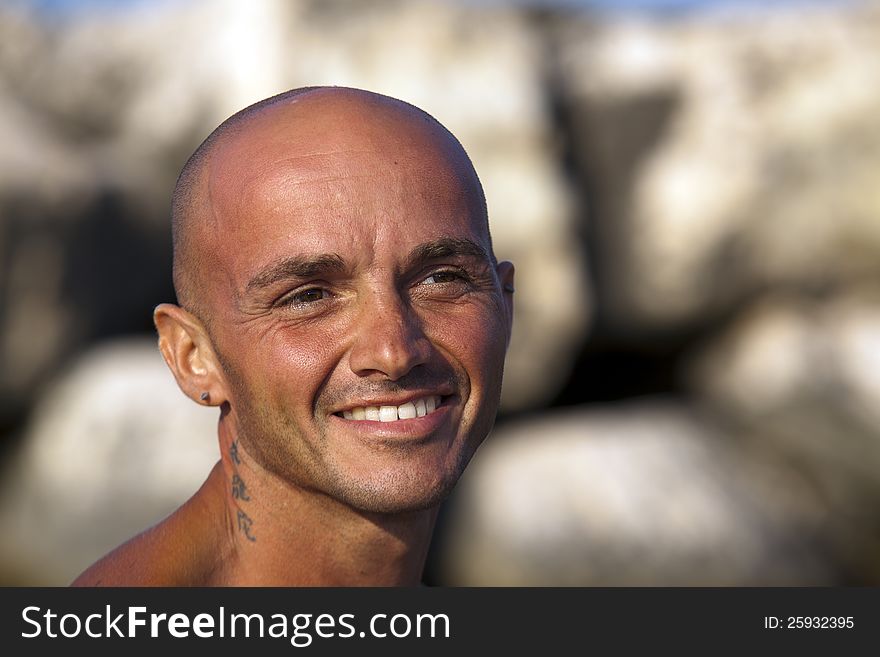 Very muscular young tourist at the beach with great care for his body. Very muscular young tourist at the beach with great care for his body