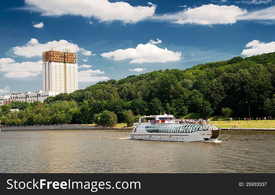 Tourist boat floats on the Moskva River on a sunny day in downtown Moscow, Russia. Tourist boat floats on the Moskva River on a sunny day in downtown Moscow, Russia