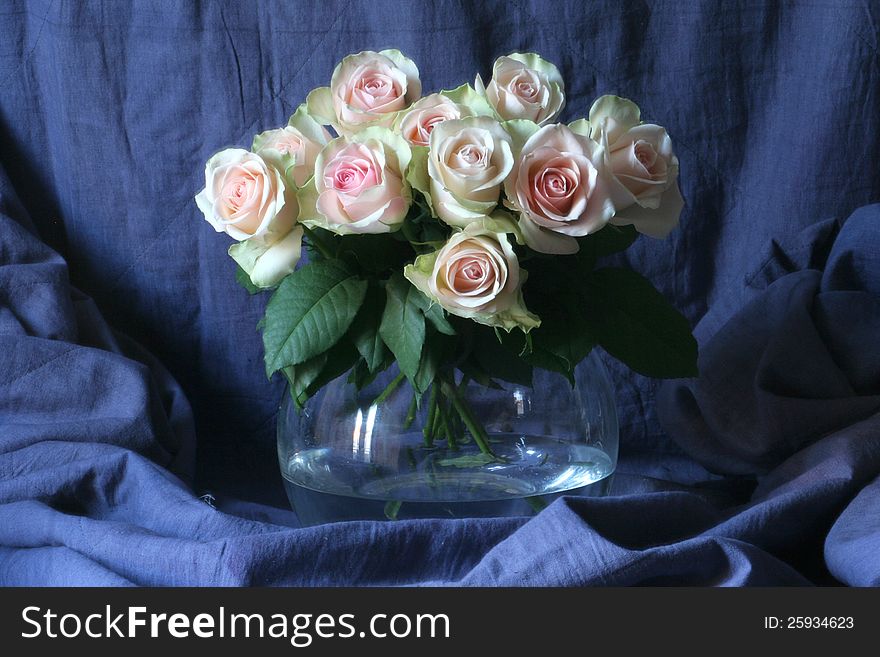 Vase with pink roses in water on blue background. Vase with pink roses in water on blue background