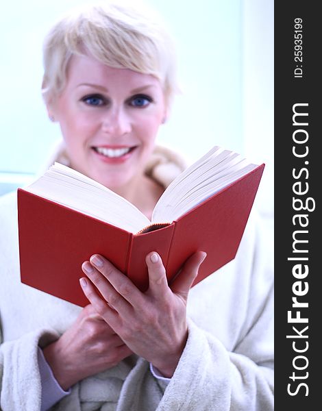 Image of a woman reading a book the library