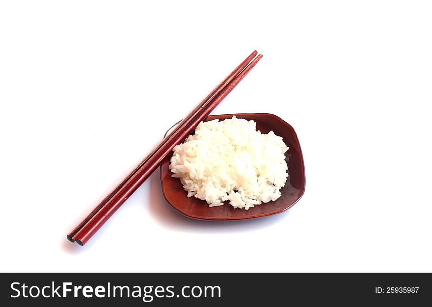 Rice on dish and chopsticks on a white background.