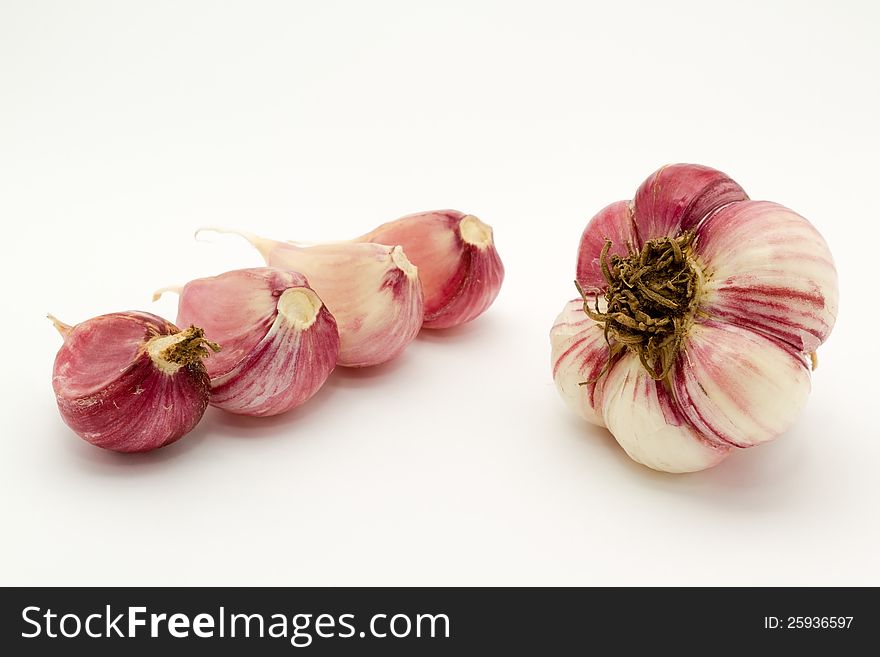 Winter garlic cloves, isolated on white.