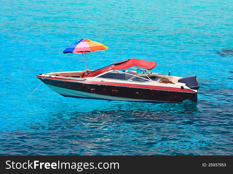 Speed boat with umbrella on deck at blue lagoon. Speed boat with umbrella on deck at blue lagoon