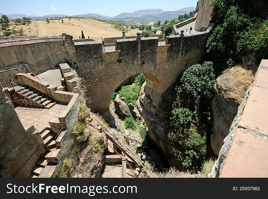 Roman bridge in Ronda, one of the famous white villages in MÃ¡laga, Andalusia, Spain. Roman bridge in Ronda, one of the famous white villages in MÃ¡laga, Andalusia, Spain