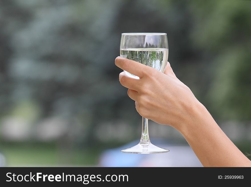 Woman's hand with a glass of water. Woman's hand with a glass of water