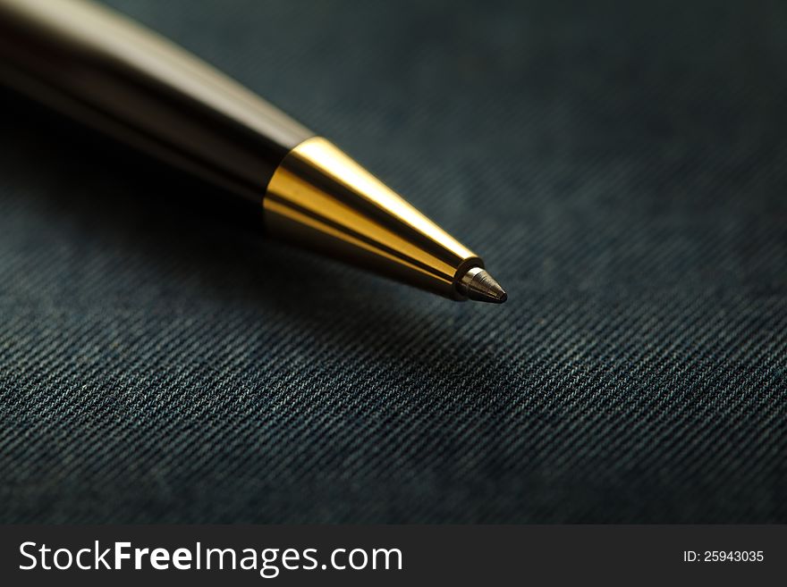 Black and Golden ball Pen over textured background