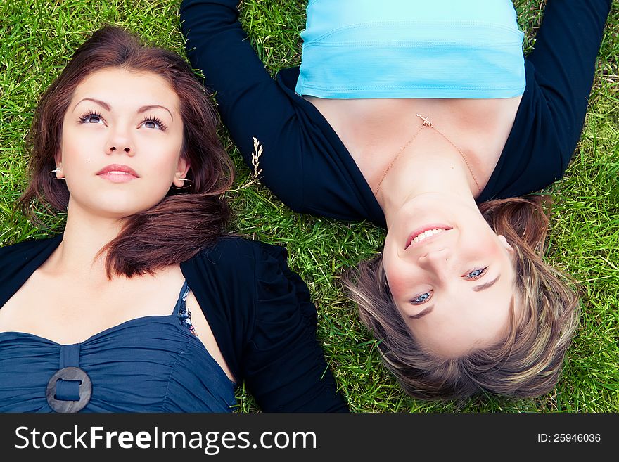 Two girls lying on grass