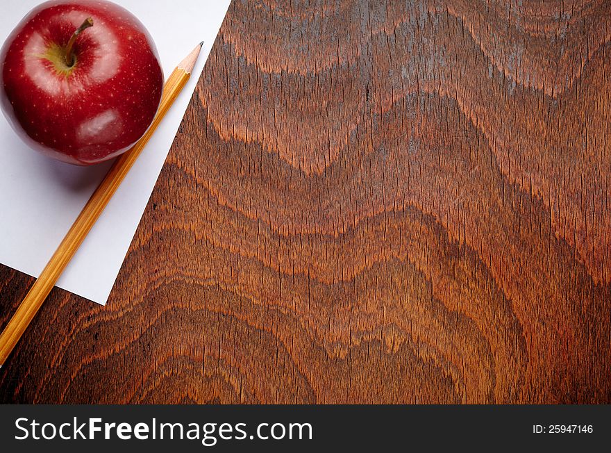 Apple and a pencil on a school notebook