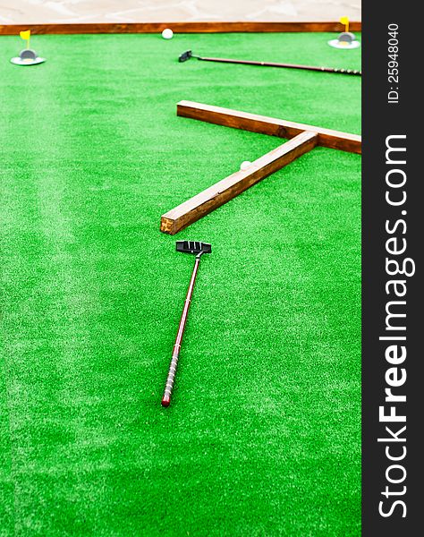 Mini golf field with ball and golf club
