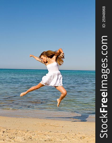 Young  woman jumping on the beach