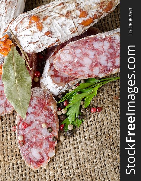 Salami sausage and spices in the tissue. Salami sausage and spices in the tissue