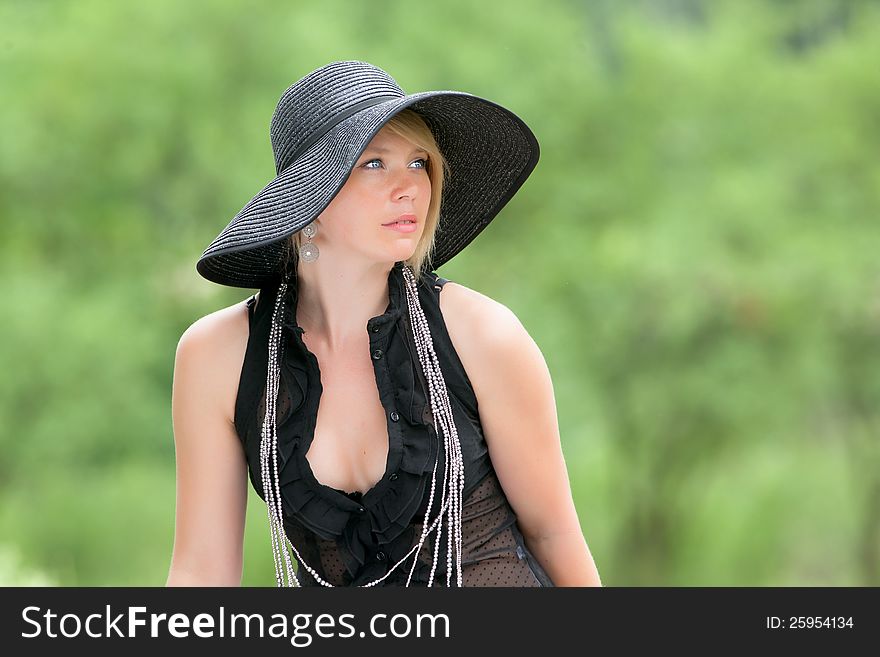 Blue-eyed girl with a hat on a green background. Blue-eyed girl with a hat on a green background