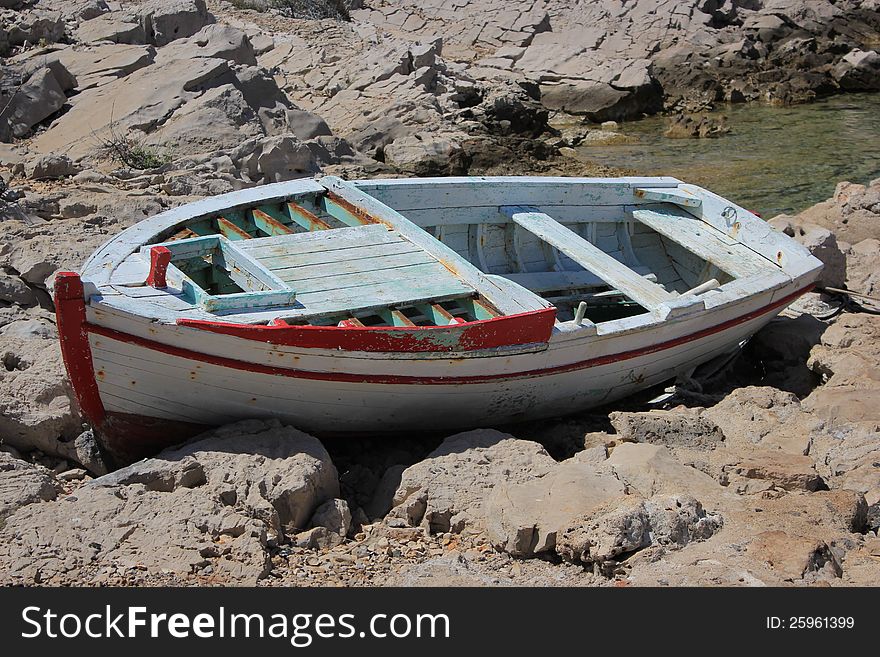 Old wooden boat jobless resting ashore - Adriatic landscape. Old wooden boat jobless resting ashore - Adriatic landscape