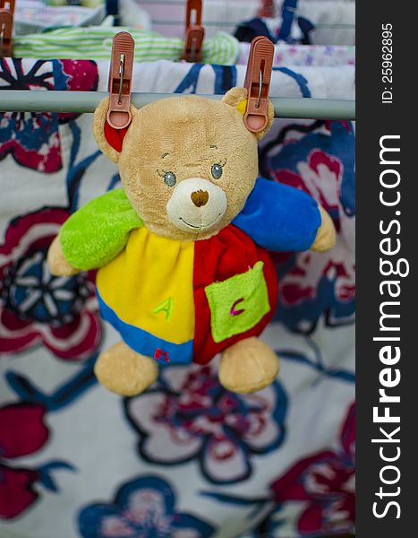Colorful toys-teddy bear drying with the laundry. Colorful toys-teddy bear drying with the laundry