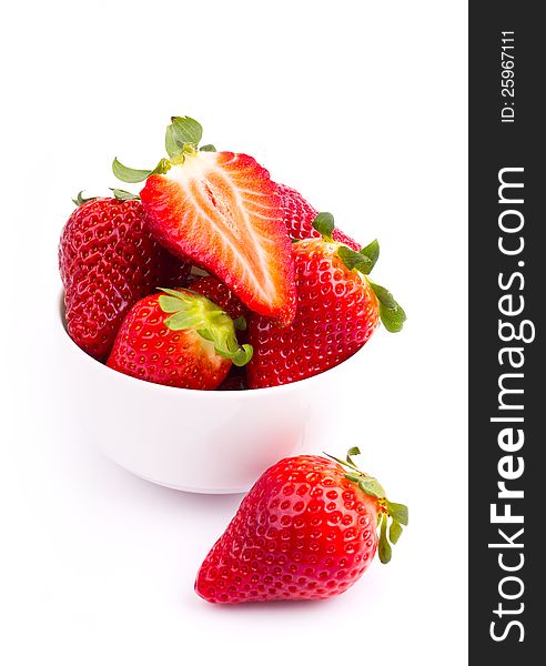 Fresh strawberries in the bowl on the white background