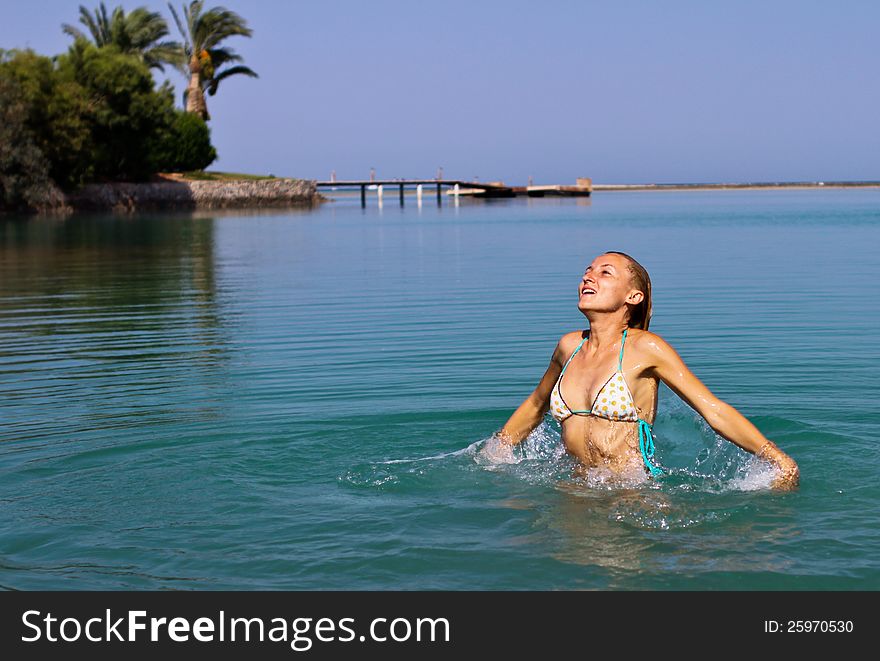 Happy young women playing in the lagoon in El Gouna, Egypt. Happy young women playing in the lagoon in El Gouna, Egypt