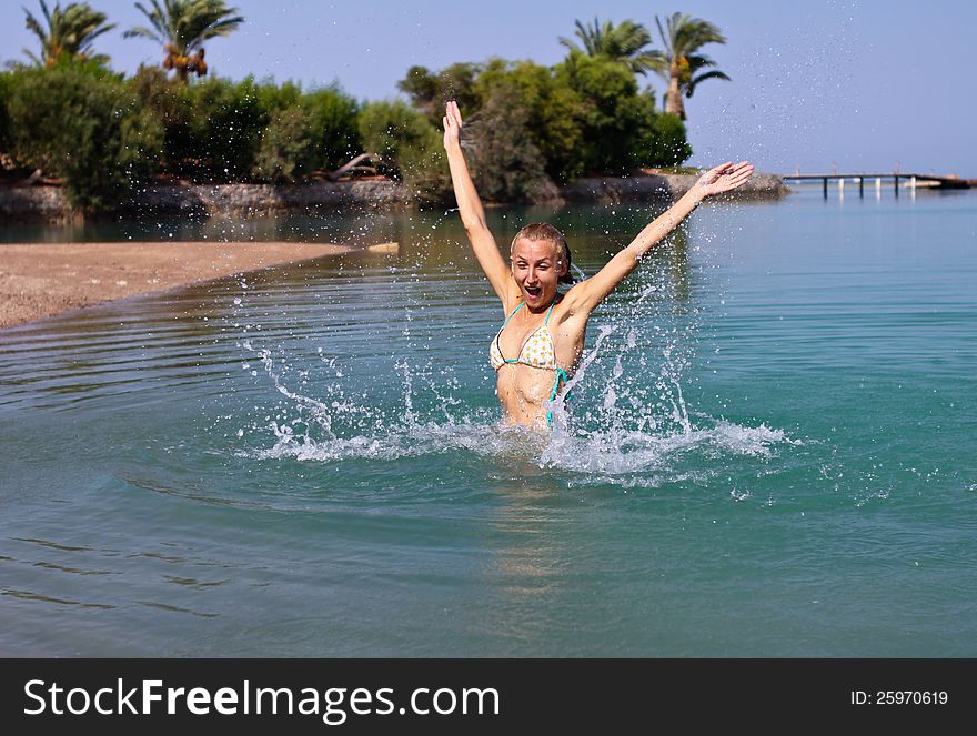 Happy young women playing in the lagoon in El Gouna, Egypt. Happy young women playing in the lagoon in El Gouna, Egypt