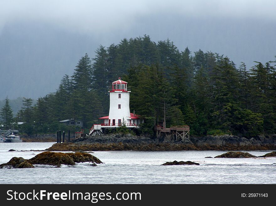 A lighthouse standing on a rocky shoreline