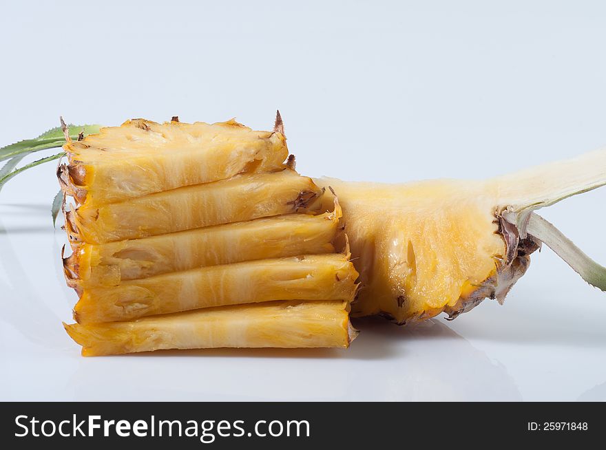 Pineapple section and slices on white background