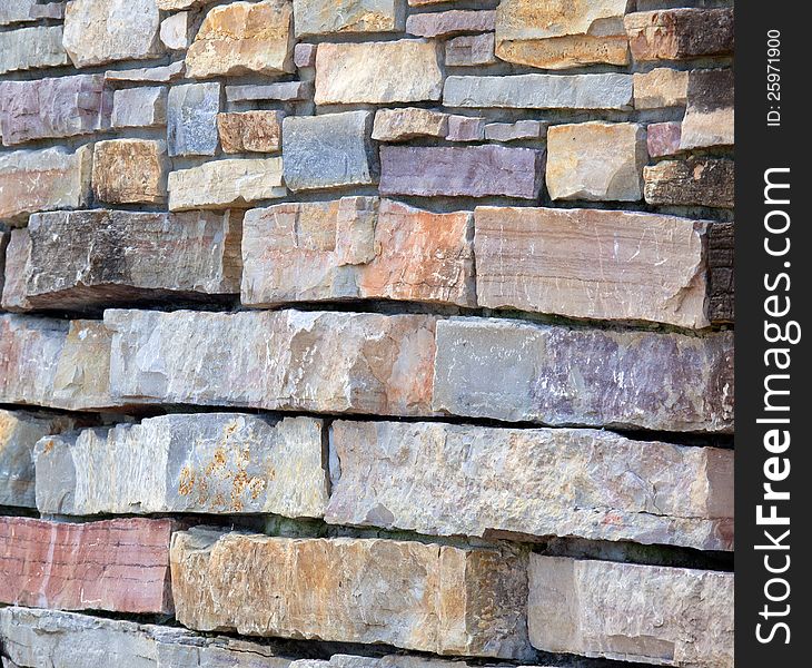 Multicolored pieces of flagstone make for a beautiful wall. Multicolored pieces of flagstone make for a beautiful wall.