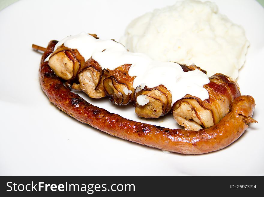 Grilled chicken and sausage with mash and tartar sauce. Grilled chicken and sausage with mash and tartar sauce.
