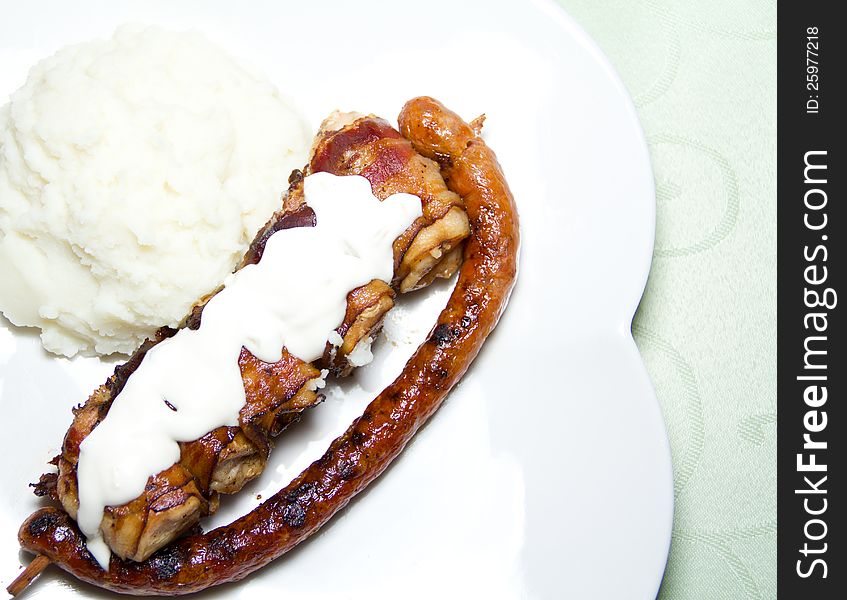 Grilled chicken and sausage with mash and tartar sauce. Grilled chicken and sausage with mash and tartar sauce.