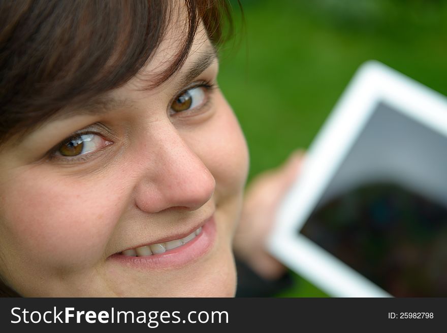 Yougn woman with tablet pc looking up