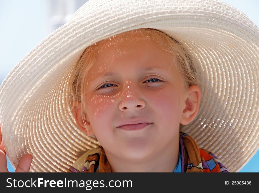 Portrait of a girl wearing a hat on a summer day