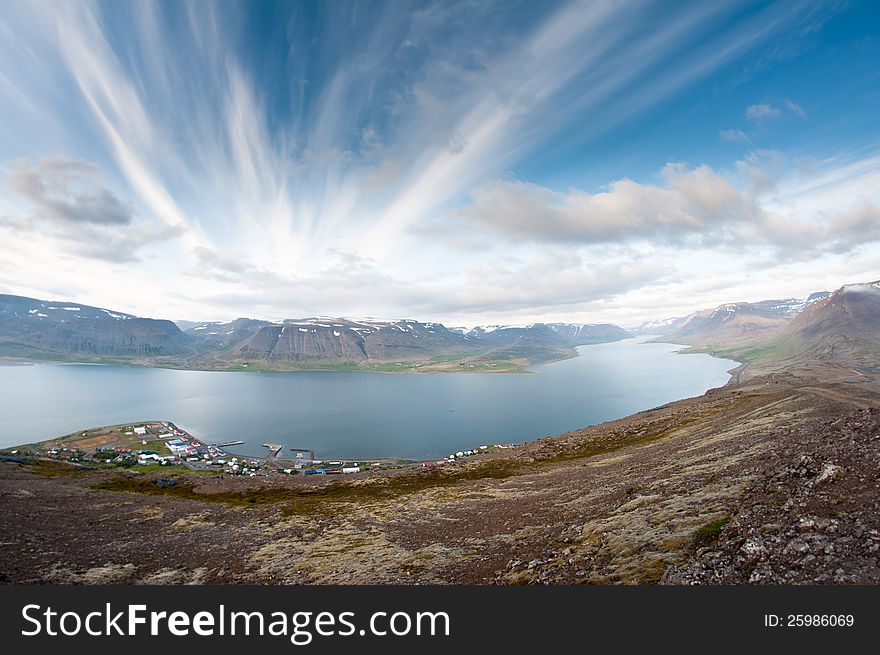 Fjord surrounded by beautiful mountains bathing in evening light. Fjord surrounded by beautiful mountains bathing in evening light