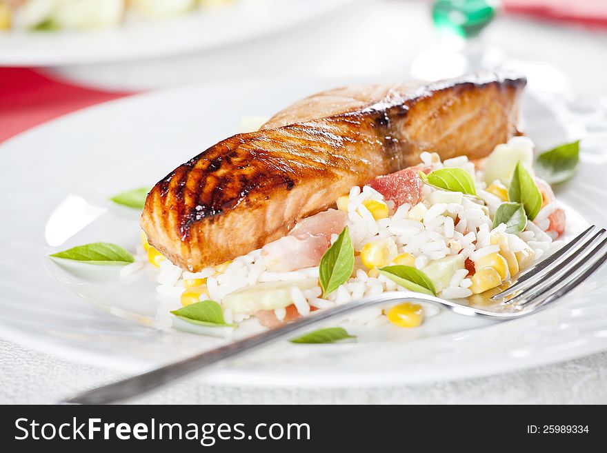 Close up photograph of a salmon filet with rice salad. Close up photograph of a salmon filet with rice salad