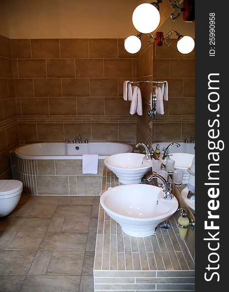 Interior of elegant modern bathroom with luminous lamps. Interior of elegant modern bathroom with luminous lamps