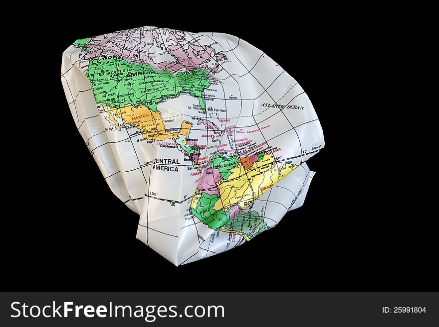 Earth globus colapsing in itself, isolated in black background. Earth globus colapsing in itself, isolated in black background.