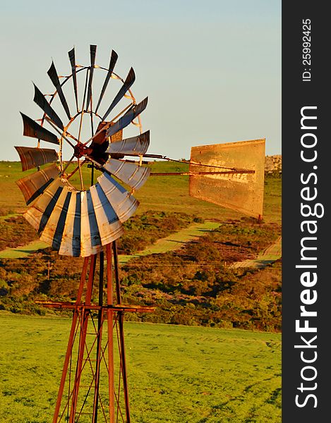 Landscape with windmill water pump on a farm westerncape south africa