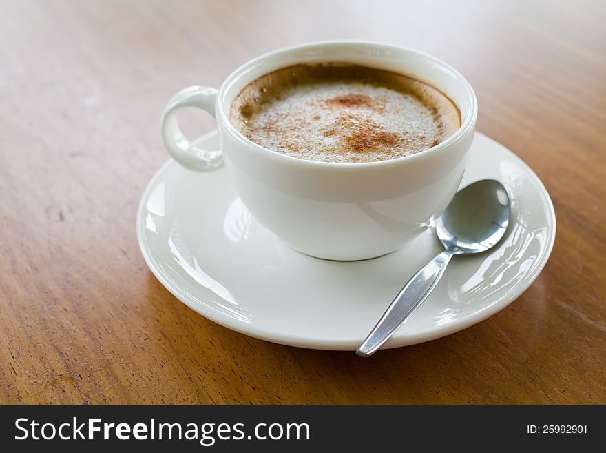 Cappuccino coffee on wood table