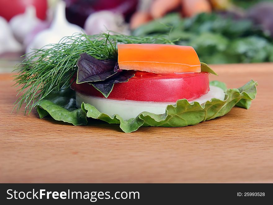 Fresh chopped vegetables on a wooden board close-up. Fresh chopped vegetables on a wooden board close-up