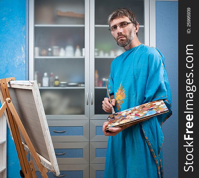Artist paints picture in the studio